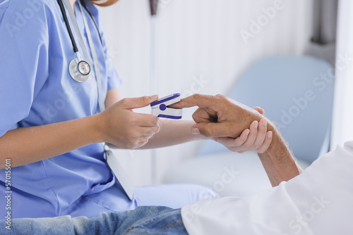 closeup nurse doctor using fingertip pause oximeter measures blood oxygen saturation level with patient