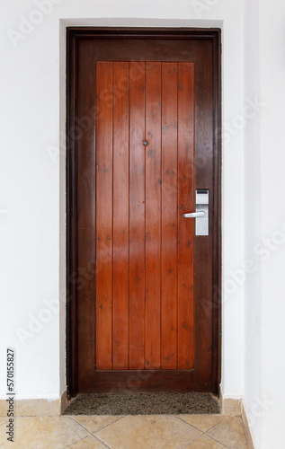 Wooden door on a white wall.
