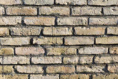 Brick wall background. Home facade texture. Grunge industrial pattern. Yellow brown design. Simple brickwall background.