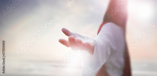Foto Resurrected Jesus Christ reaching out with open arms in the sky, heaven and cros