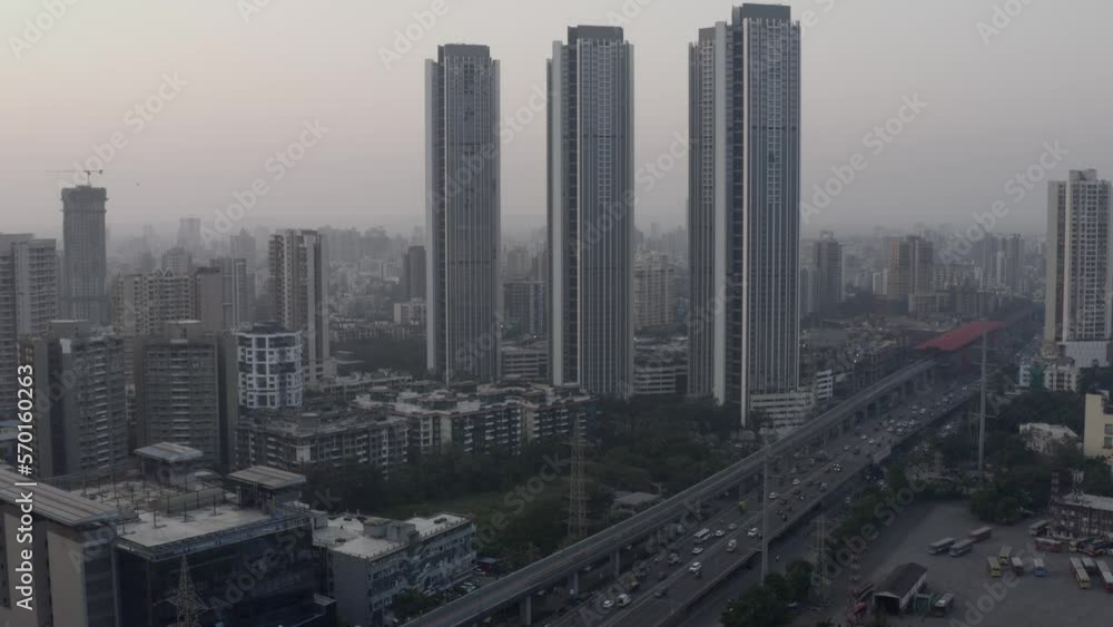 Mumbai Suburban Skyline With City Buildings And Transport Vehicles Running On Highway Road During Rush Hour. - Aerial Drone Tilted Up Mumbai Suburban Skyline With City Buildings And Transport Vehicles Running On Highway Road During Rush Hour. - Aerial Drone Tilted Up