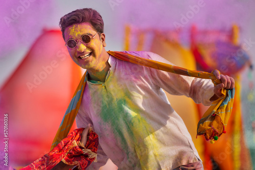 a young man happily dancing during holi celebrations