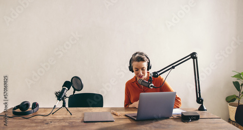 Fotografi Female radio dj preparing a show in a studio