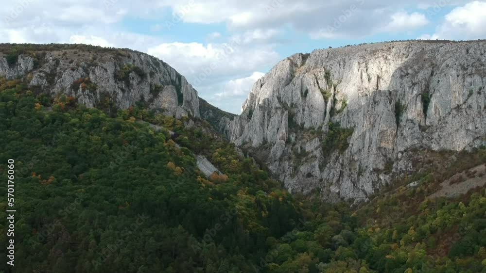 Aerial shot of a drone over mountains in Romania on a sunny day Aerial shot of a drone over mountains in Romania on a sunny day