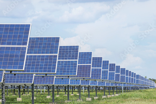 rows array of polycrystalline silicon solar cells or photovoltaic cells in solar power plant station turn up skyward absorb the sunlight from the sun 