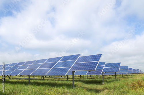 Rows array of   Solar cells or solar module or solar panels in solar power plant turn up skyward absorb the sunlight from the sun use light energy to generate electricity 