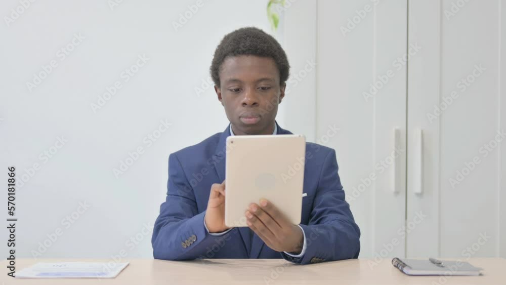 Young African Businessman using Digital Tablet, Browsing Internet Young African Businessman using Digital Tablet, Browsing Internet