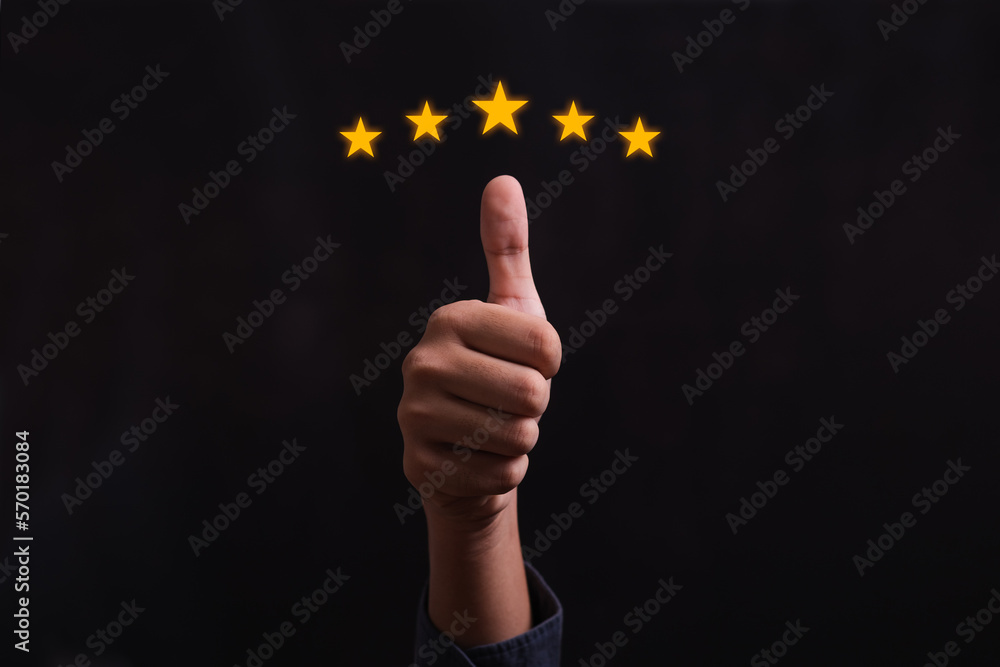 Close up of man customer giving a five star rating. Using technology for Review, Service rating, satisfaction, Customer service experience and satisfaction survey concept. Close up of man customer giving a five star rating. Using technology for Review, Service rating, satisfaction, Customer service experience and satisfaction survey concept.