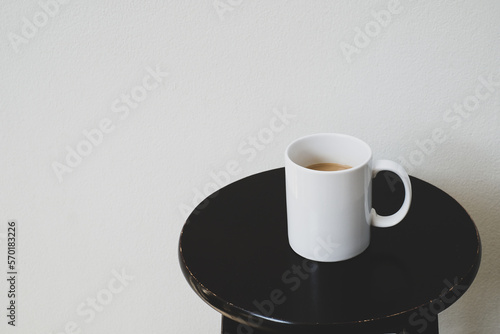 White cup of hot coffee on wooden table, soft focus.