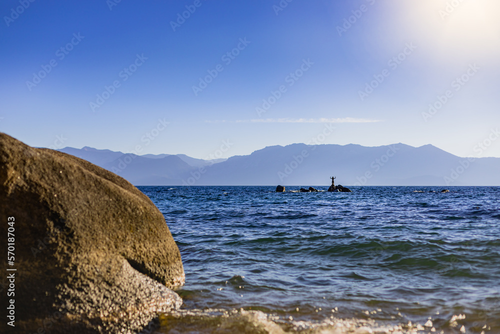 Mountain Lake Swimmer on a Boulder for Travel and Adventure Mountain Lake Swimmer on a Boulder for Travel and Adventure