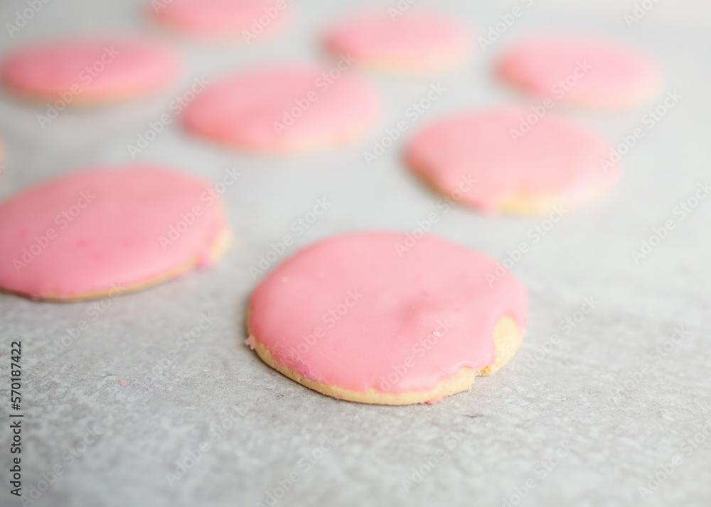sugar cookies with pink frosting on gray kitchen island sugar cookies with pink frosting on gray kitchen island