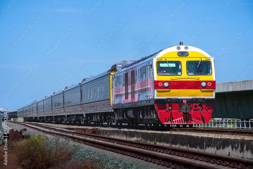 Passenger train by diesel locomotive on the railway.