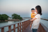 happiness travel baby and mom sunset water atmosphere on sea ,asian baby and mother travel outdoor