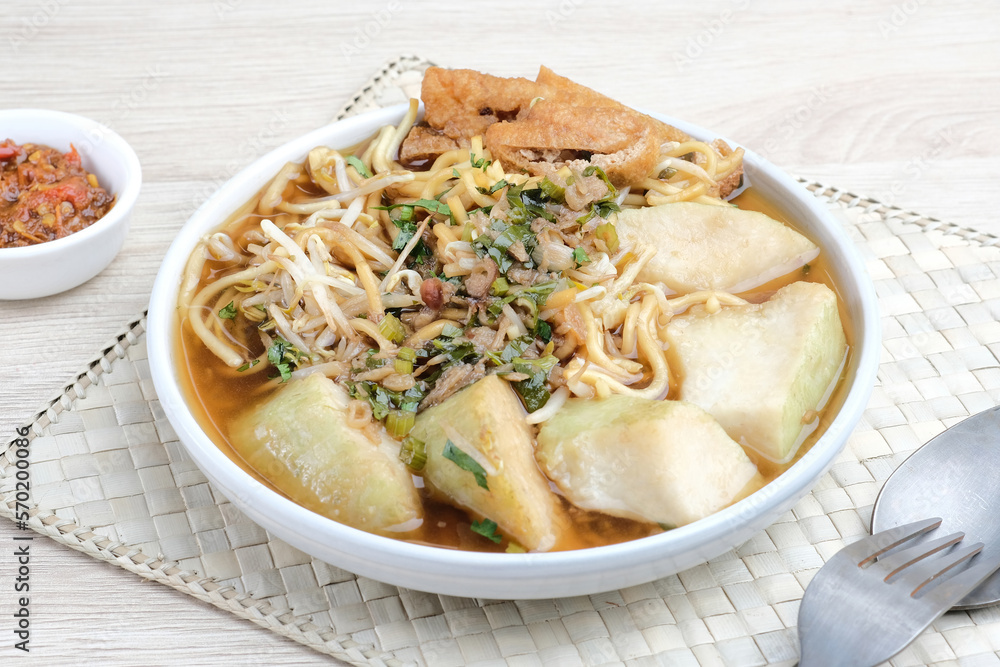 Mie Kopyok, a traditional noodle from Semarang, Central Java, Indonesia. Noodle mixed with lontong (rice cake), tofu, bean sprouts, leeks and crackers. Served with sambal (chilli sauce).
