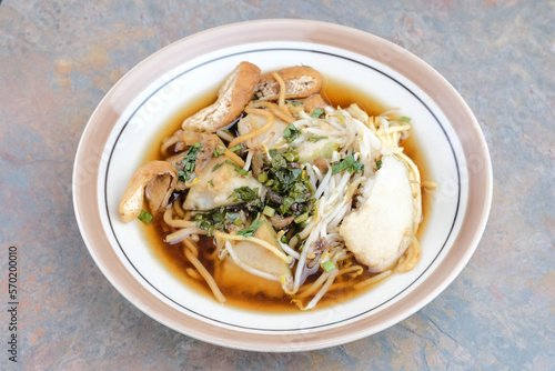 Mie Kopyok, a traditional noodle from Semarang, Central Java, Indonesia. Noodle mixed with lontong (rice cake), tofu, bean sprouts, leeks and crackers. Served with sambal (chilli sauce). 