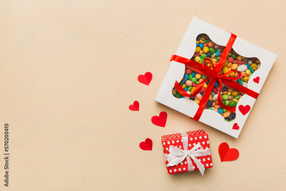 Valentine day composition: sweet candy, with gift boxes with bow and red felt hearts, photo template, background. Top View with copy space Valentine day composition: sweet candy, with gift boxes with bow and red felt hearts, photo template, background. Top View with copy space
