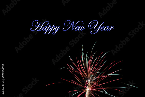 Real fireworks photography and abstract colorful fireworks background with Happy New Year lettering