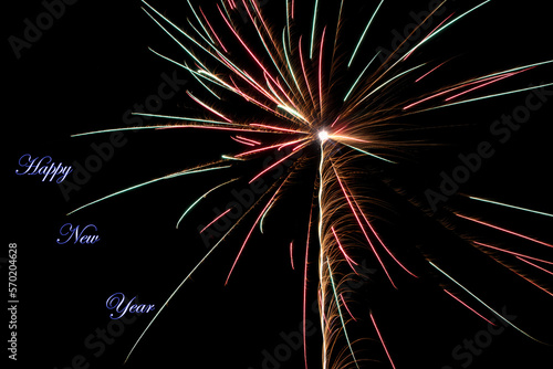 Real fireworks photography and abstract colorful fireworks background with Happy New Year lettering
