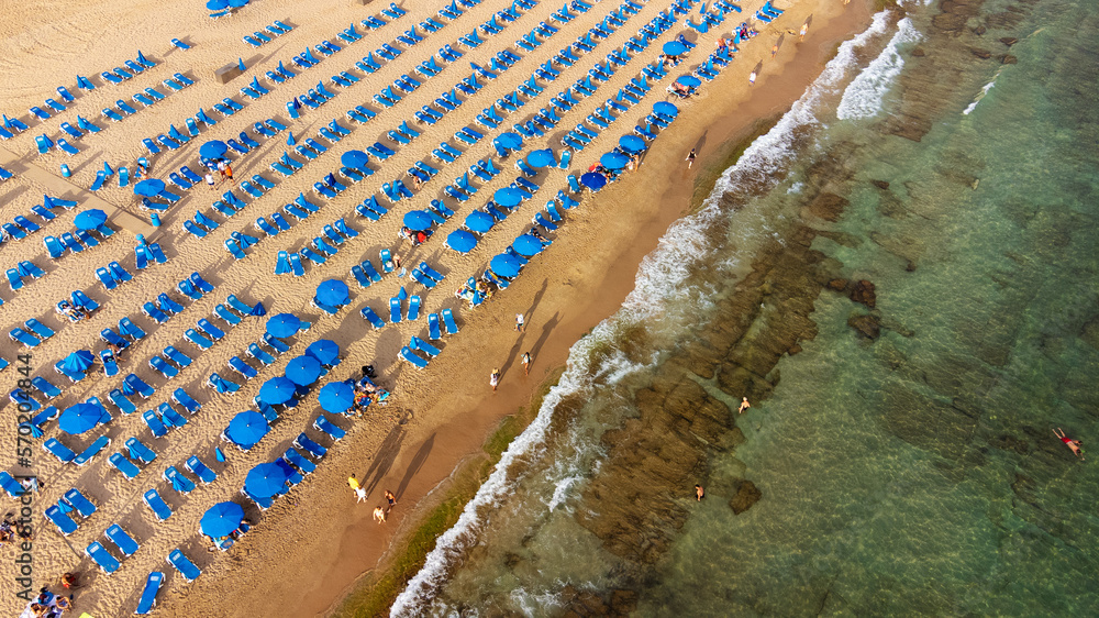 summer and travel concept - beautiful aerial view of summer beach with tourists, sunbeds and umbrellas in Benidorm, Spain