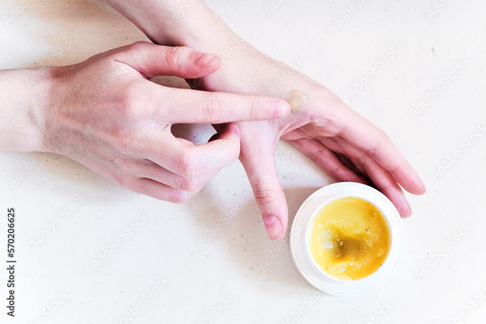 Natural organic salve (balm, cream) in hands with wooden spoon Natural organic salve (balm, cream) in hands with wooden spoon