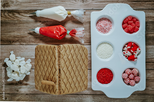 Gingerbread house decorating setup with red & white theme photo