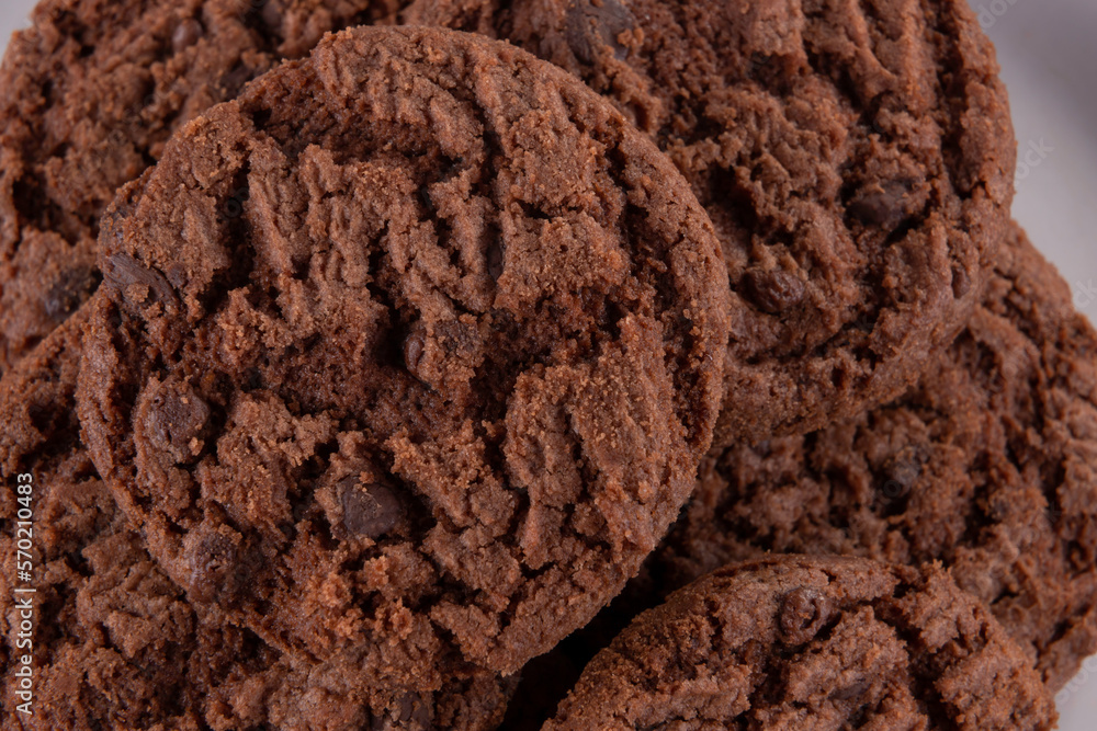 Tasty chocolate chip cookies on white plate on wooden background. Selective focus. Tasty chocolate chip cookies on white plate on wooden background. Selective focus.