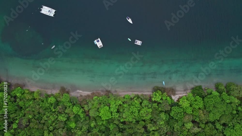Boats anchored in the sea, in the beautiful Jicaro beach in Costa Rica. photo