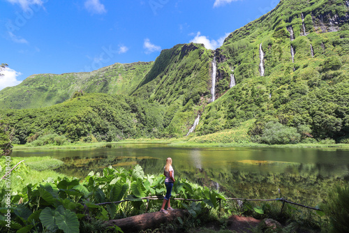 View of the idyllic Poço da Alagoinha lagoon at Flores island in Azores

Several waterfalls that spring from the mountain and feed the lagoon in which they are reflected photo
