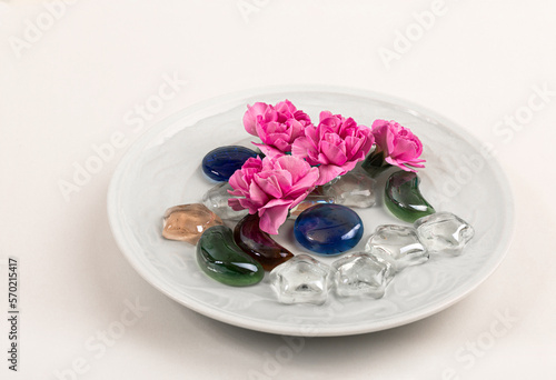 There are water and carnations in the bowl