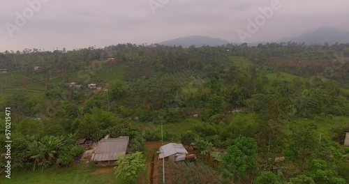 Rural Ecuadorian town with misty mountains and fields in the distance