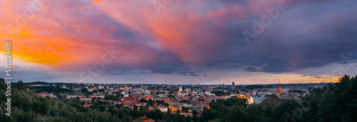 Vilnius, Lithuania. Sunset Dramatic Sky Above Historic Center Cityscape. Old Town Travel Panorama In Night Illuminations. Unesco World Heritage Site. Sts Johns' Church. Amazing Sunset Sunrise Sky.