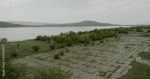 Concrete dyke wall with bridge on shore of Dali Mta reservoir, Georgia. photo