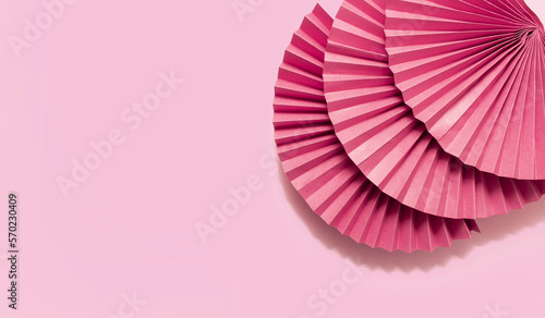 Pink circle handmade paper fans on pink background. Chinese New Year 2023 background