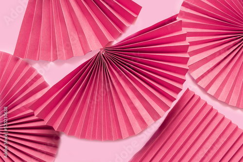 Pink circle handmade paper fans on pink background. Chinese New Year 2023 background