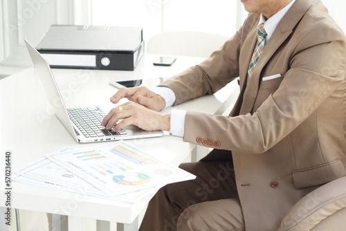 Close up of CEO businessman in suit using laptop. Male hands using laptop in modern office.