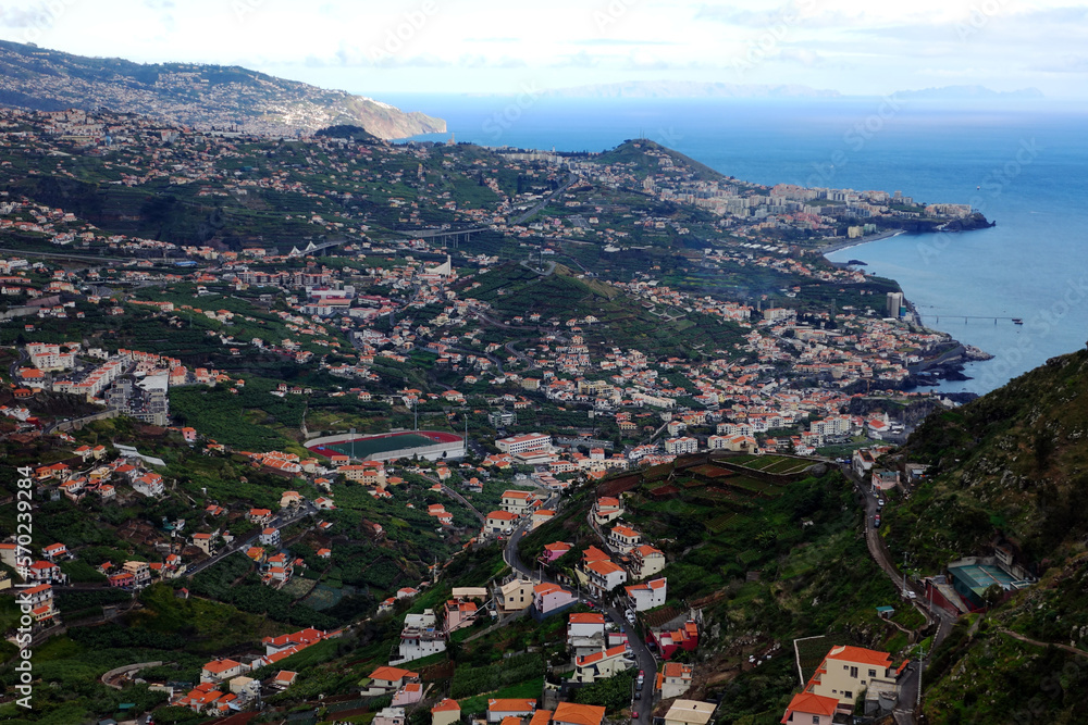 A typical view across Madeira above Funchal, showing patchwork of fields and houses with tunnels