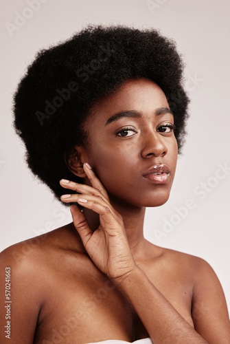 Portrait, natural or skincare and a model black woman in studio on a gray background with afro hair. Skin, cosmetics and beauty with an attractive young female posing indoor for health or wellness