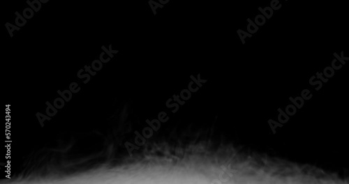 White smoke on a black background slowly spreads along the bottom