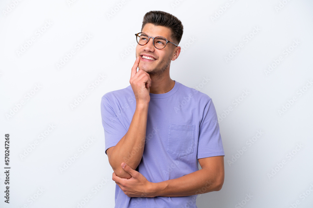 Young caucasian man isolated on white background thinking an idea while looking up Young caucasian man isolated on white background thinking an idea while looking up