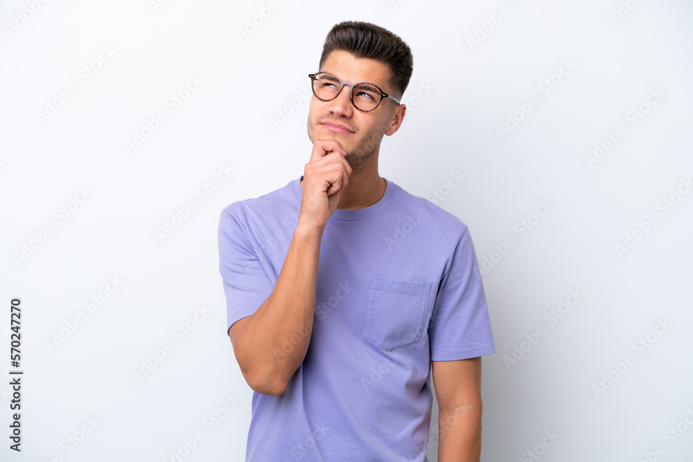 Young caucasian man isolated on white background and looking up Young caucasian man isolated on white background and looking up