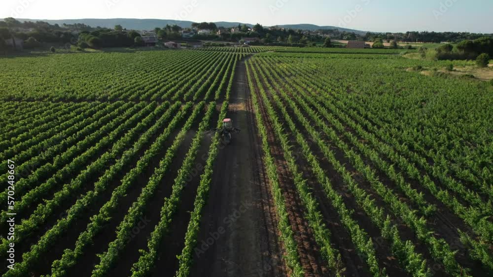 Aerial tracking shot of a farmer spraying toxic pestisides over the vineyards near Montpellier Aerial tracking shot of a farmer spraying toxic pestisides over the vineyards near Montpellier