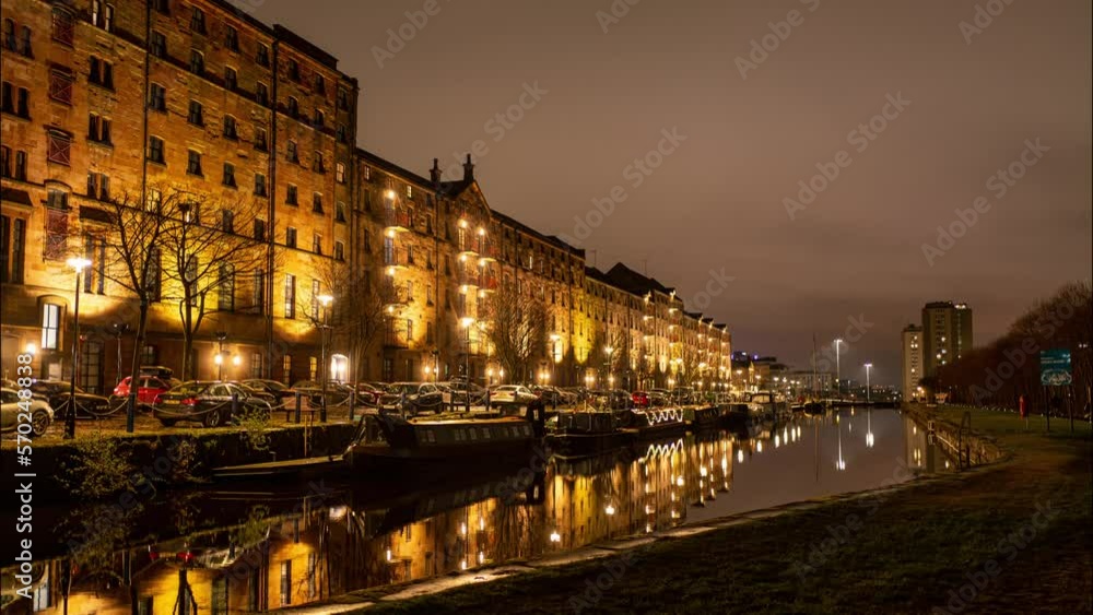 Static shot of the canalways and boathouses in the center of Glasgow with lit up sandstone buildings Static shot of the canalways and boathouses in the center of Glasgow with lit up sandstone buildings