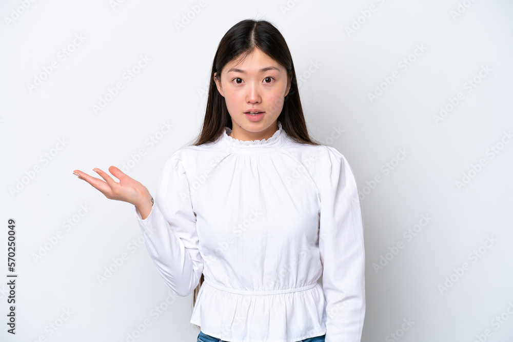 Young Chinese woman isolated on white background making doubts gesture Young Chinese woman isolated on white background making doubts gesture