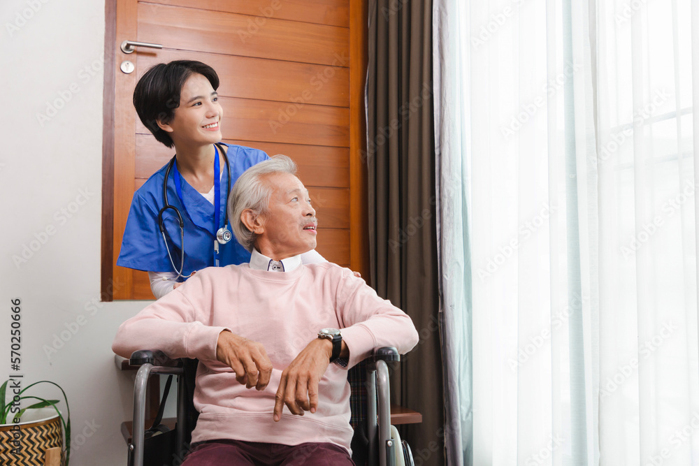 Friendly staff caregiver of nursing home talking to asian senior man in living room Friendly staff caregiver of nursing home talking to asian senior man in living room
