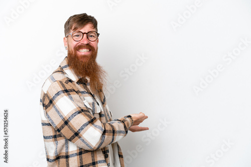 Redhead man with long beard isolated on white background extending hands to the side for inviting to come