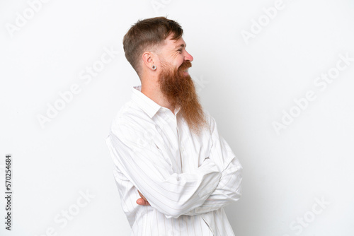 Redhead man with long beard isolated on white background looking side © luismolinero
