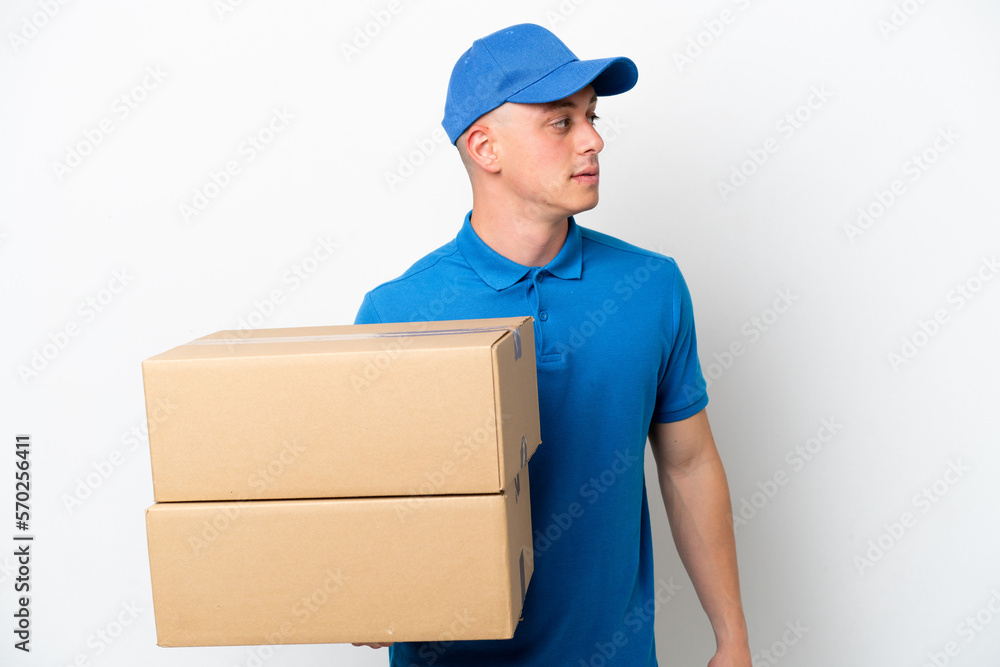 Young delivery Brazilian man isolated ops white background looking to the side Young delivery Brazilian man isolated ops white background looking to the side