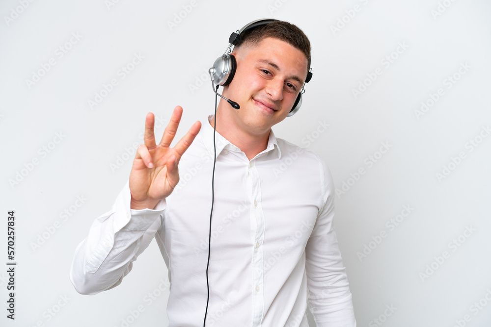 Telemarketer Brazilian man working with a headset isolated on white background happy and counting three with fingers Telemarketer Brazilian man working with a headset isolated on white background happy and counting three with fingers