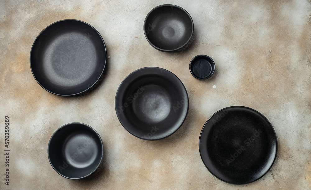 Empty plates on beige background. A collection of various craft plates. Handmade ceramics. top view Empty plates on beige background. A collection of various craft plates. Handmade ceramics. top view