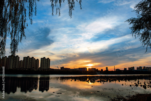 The river in the city Park reflects the city skyline against a beautiful and spectacular sunset backdrop.